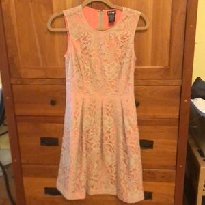 A-line sleeveless beige lace over coral underlay.